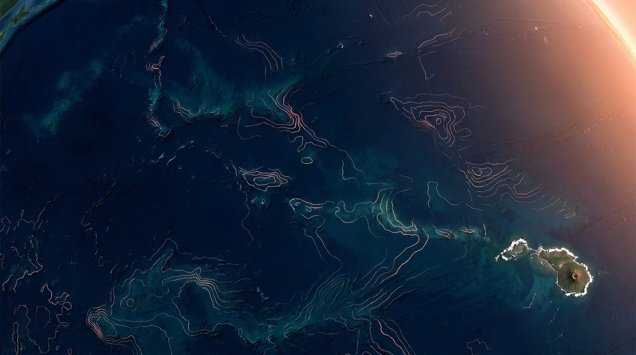 Aerial view of Pearl Harbor and the Hawaiian Pacific coastline at sunset — the operational center of the INDOPACOM defense supply chain
